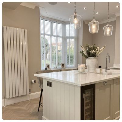 White wooden blinds in a dark grey panelled dining room