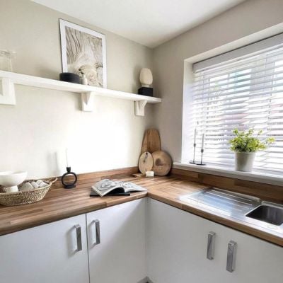 White wooden blinds in a bright, white and wood kitchen