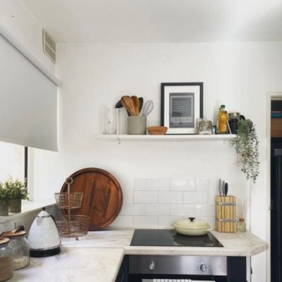 Pale grey roller blind in a white modern kitchen