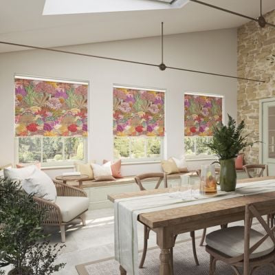 A bold abstract roller blind shown in conservatory windows